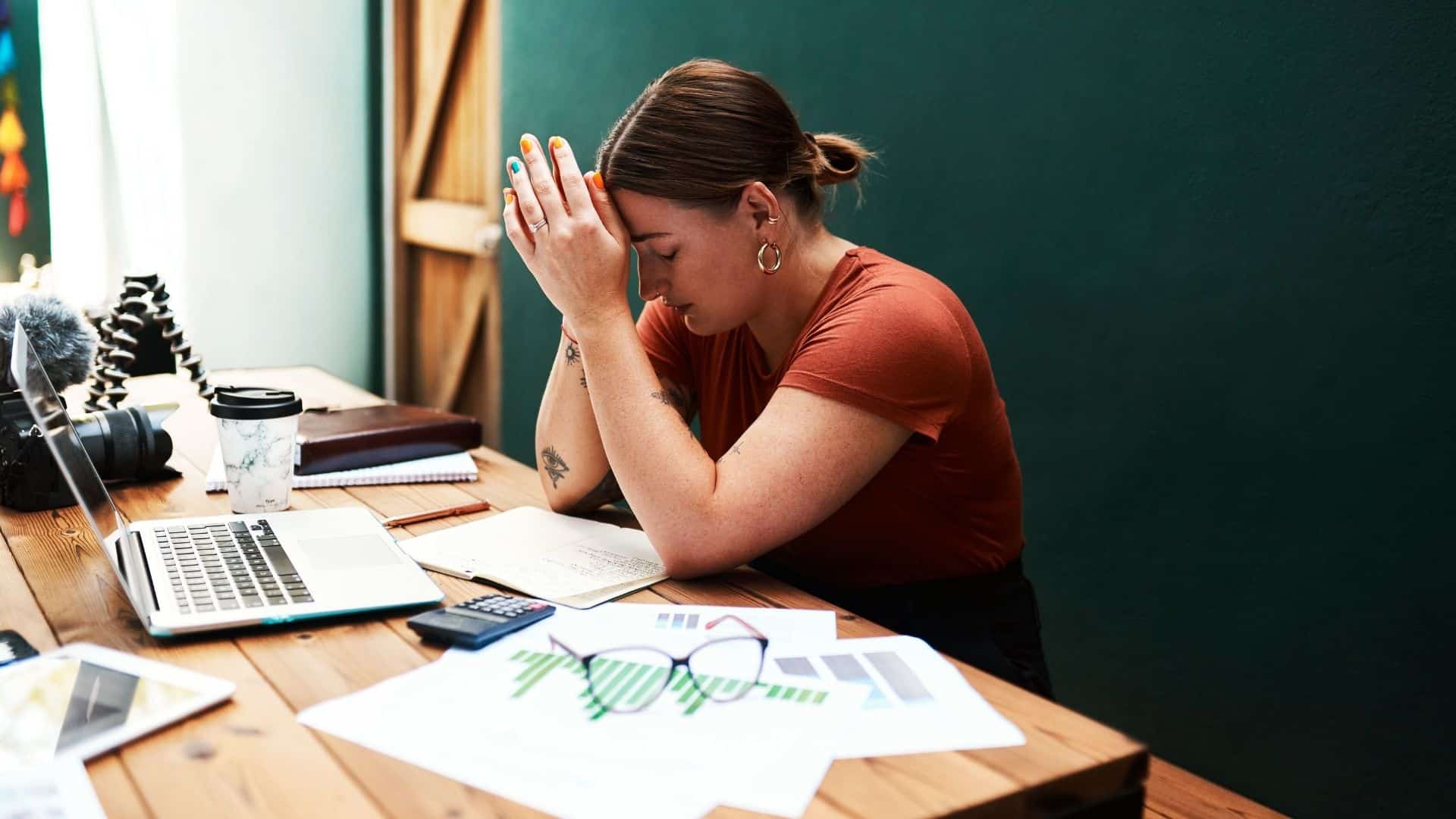 A stressed woman sitting at a desk